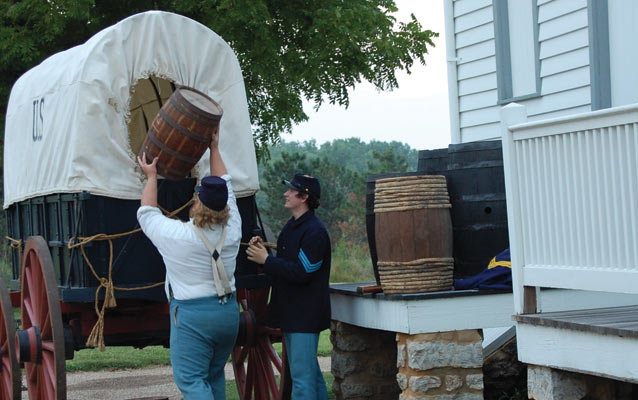 Soldiers loading a supply wagon