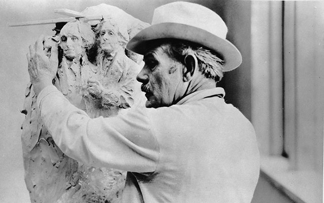 Gutzon Borglum works on an early version of his Mount Rushmore model. Gutzon Borglum works on an early version of his Mount Rushmore model.