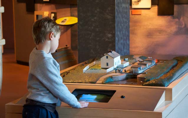 A photo of a boy watching a video at the C&O Canal Museum at Canal Place