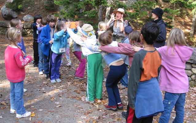 Students form a body bridge on a carriage road.