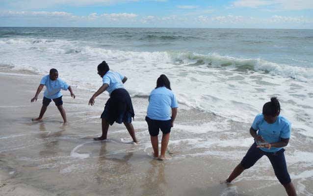 Students getting their feet wet during sand castle building Students getting their feet wet during sand castle building