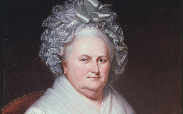 Detail, oil painting showing Martha Washington with a white lace cap with silver ribbons atop her white hair, and dark eyes with a long, thin nose. Detail, oil painting showing Martha Washington with a white lace cap with silver ribbons atop her white hair, and dark eyes with a long, thin nose.