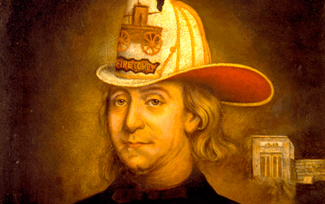 This 19th century image shows Benjamin Franklin in a Union Fire Company uniform in front of the Union Fire Company building.