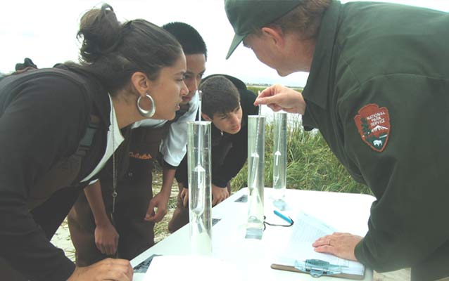 Students conducting water testing experiment with Park Ranger. Students conducting water testing experiment with Park Ranger.