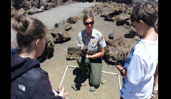 Ranger talking about rocks with students Ranger talking about rocks with students