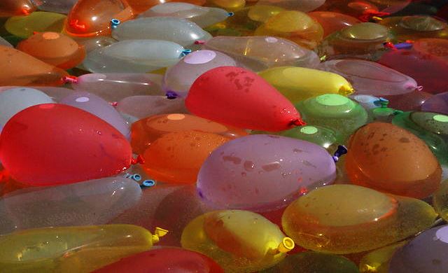 A bin full of water balloons.