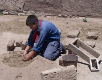 Child working with adobe Child working with adobe