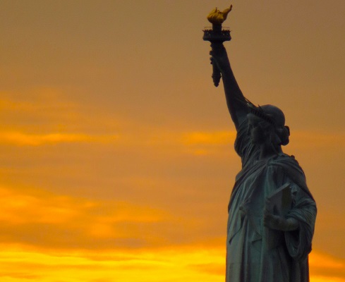 A view of the Statue of Liberty at sunset.
