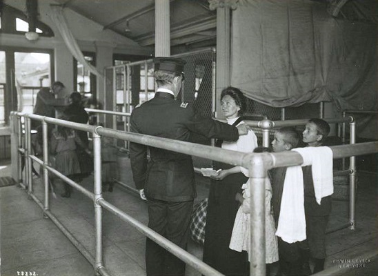 A photo circa 1911 of an immigrant family undergoing a medical examination at Ellis Island. A photo circa 1911 of an immigrant family undergoing a medical examination at Ellis Island.