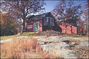 Red house in autumn landscape on Weir Farm