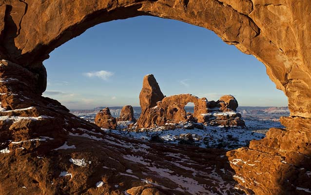 an arch in the distance is framed by another arch in the foreground an arch in the distance is framed by another arch in the foreground