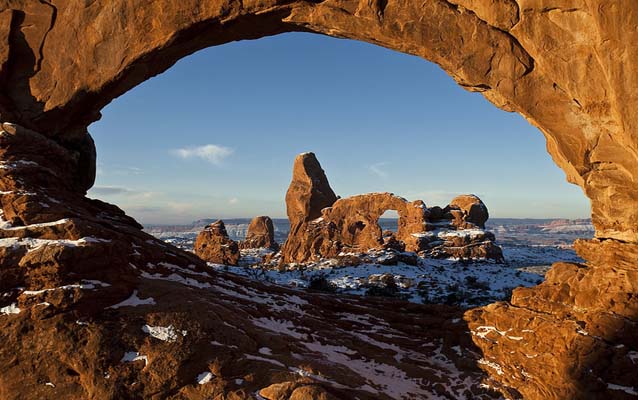 an arch in the distance is framed by another arch in the foreground