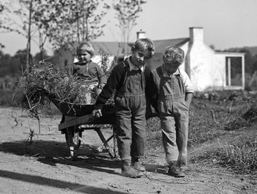 Arthurdale children with a wheelbarrow