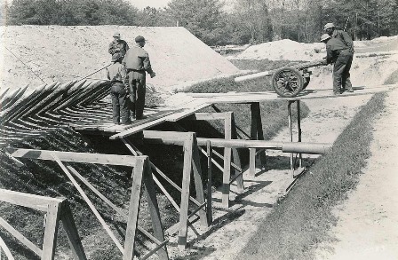 A Civilian Conservation Corps crew installs fraises as part of the reconstruction of fortifications on the Yorktown Battlefield.