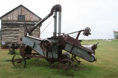 Farm implements sit outside the Palmer Epard Cabin.