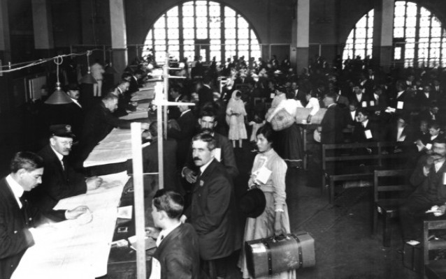 Black and white image of immigrants and officials in the Great Hall Black and white image of immigrants and officials in the Great Hall