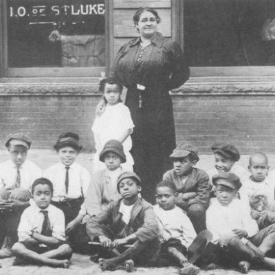 Maggie Walker and neighborhood children outside the Independent Order of Saint Luke building. 
