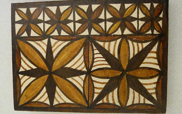 Traditional Siapo fabric featuring symmetrical designs in shades of brown Traditional Siapo fabric featuring symmetrical designs in shades of brown