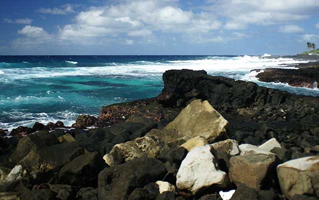 Ocean view of blue waters and a rocky shore Ocean view of blue waters and a rocky shore