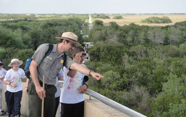 Ranger with students points to different habitats 