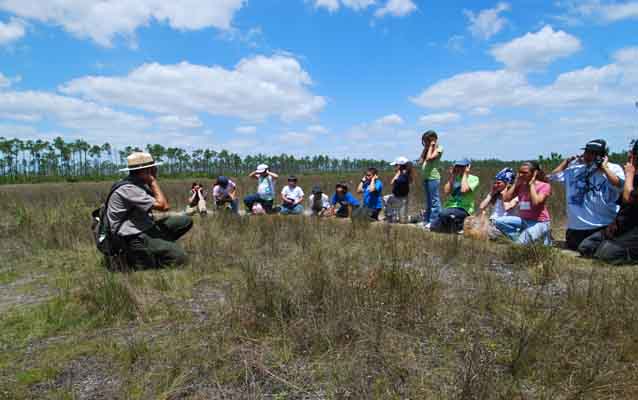 Students and Ranger in a meadow
