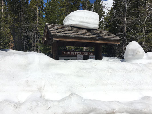 snow covers a park sign snow covers a park sign