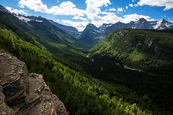 A glacially carved valley with mountains in the background. 