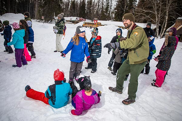 students and rangers in the snow