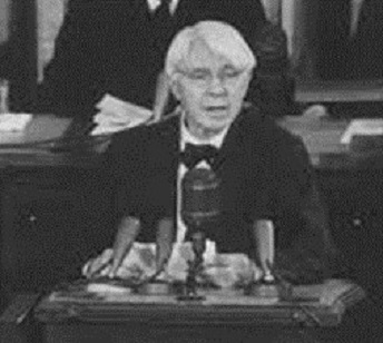 Black and White photo of Sandburg speaking to congress. Black and White photo of Sandburg speaking to congress.