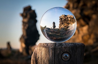 image of clear ball sitting on a post reflecting distorted images