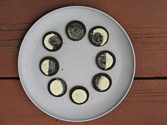 Oreo Cookies arranged in a circle as eight phases of the moon 