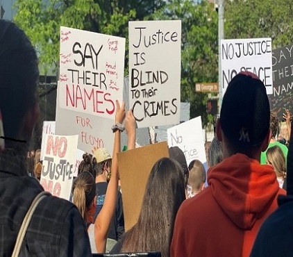 Photo of people with protest signs Photo of people with protest signs