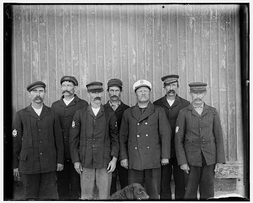 seven men in life savers uniform stand in front of a wall seven men in life savers uniform stand in front of a wall