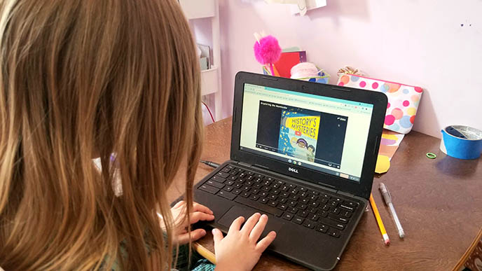 A girl completes an activity on her computer. 