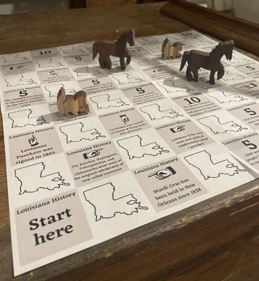 Grey and white checkered board game - wooden horses as game pieces Grey and white checkered board game - wooden horses as game pieces