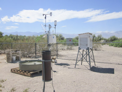 Weather monitoring equipment in a desert landscape. Weather monitoring equipment in a desert landscape.