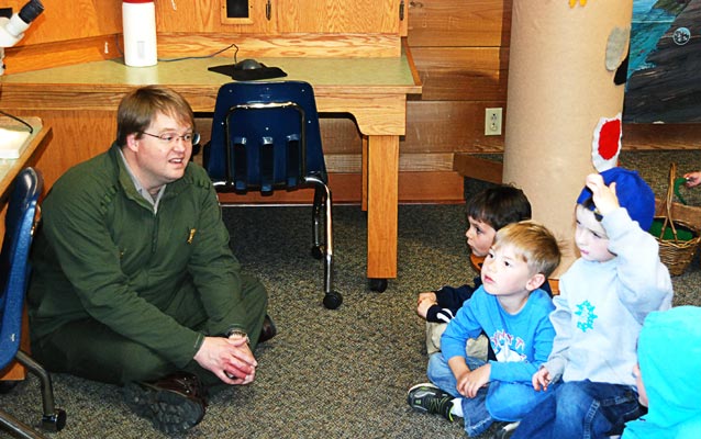 Ranger Dean discusses some of the bugs and insects viewed under a microscope with students.