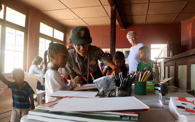 A national park ranger works with a youth on an art project at Paramount Ranch