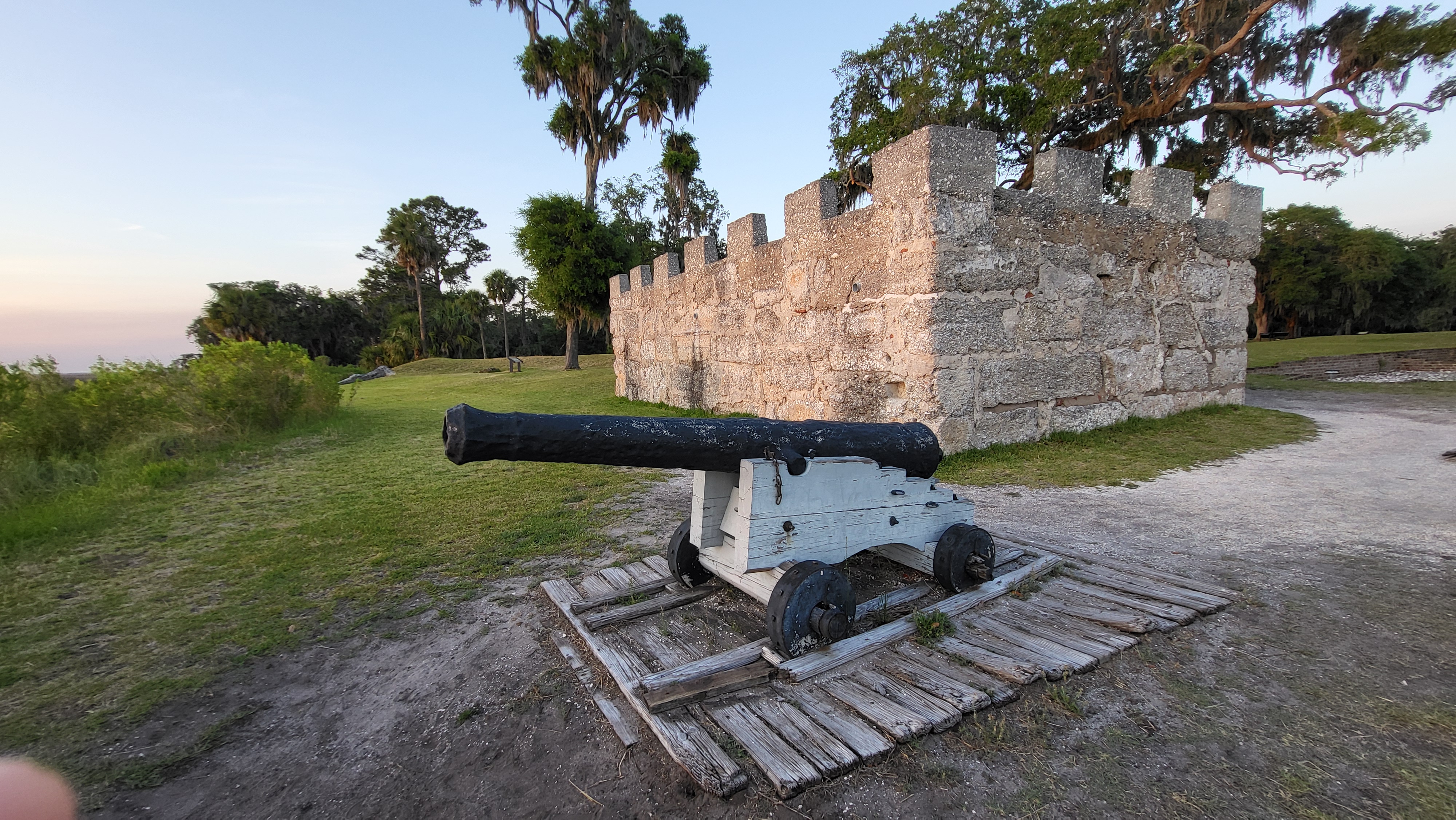 Remains of the King's Magazine, a tabby concrete fortification; grass area beside, salt marsh behind