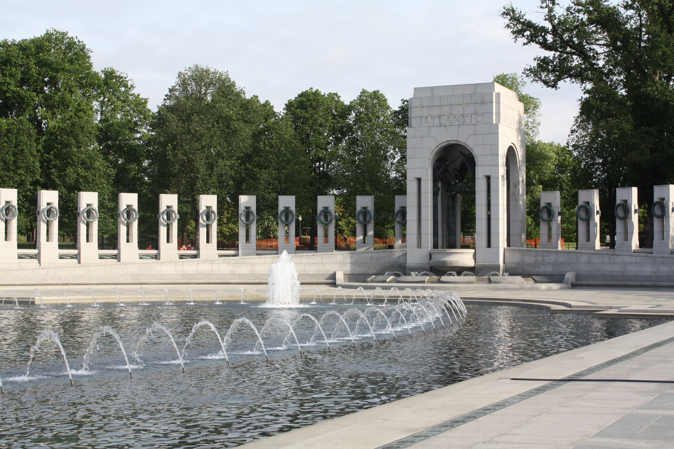 stone pillars surrounding a fountain with spouting water in the center