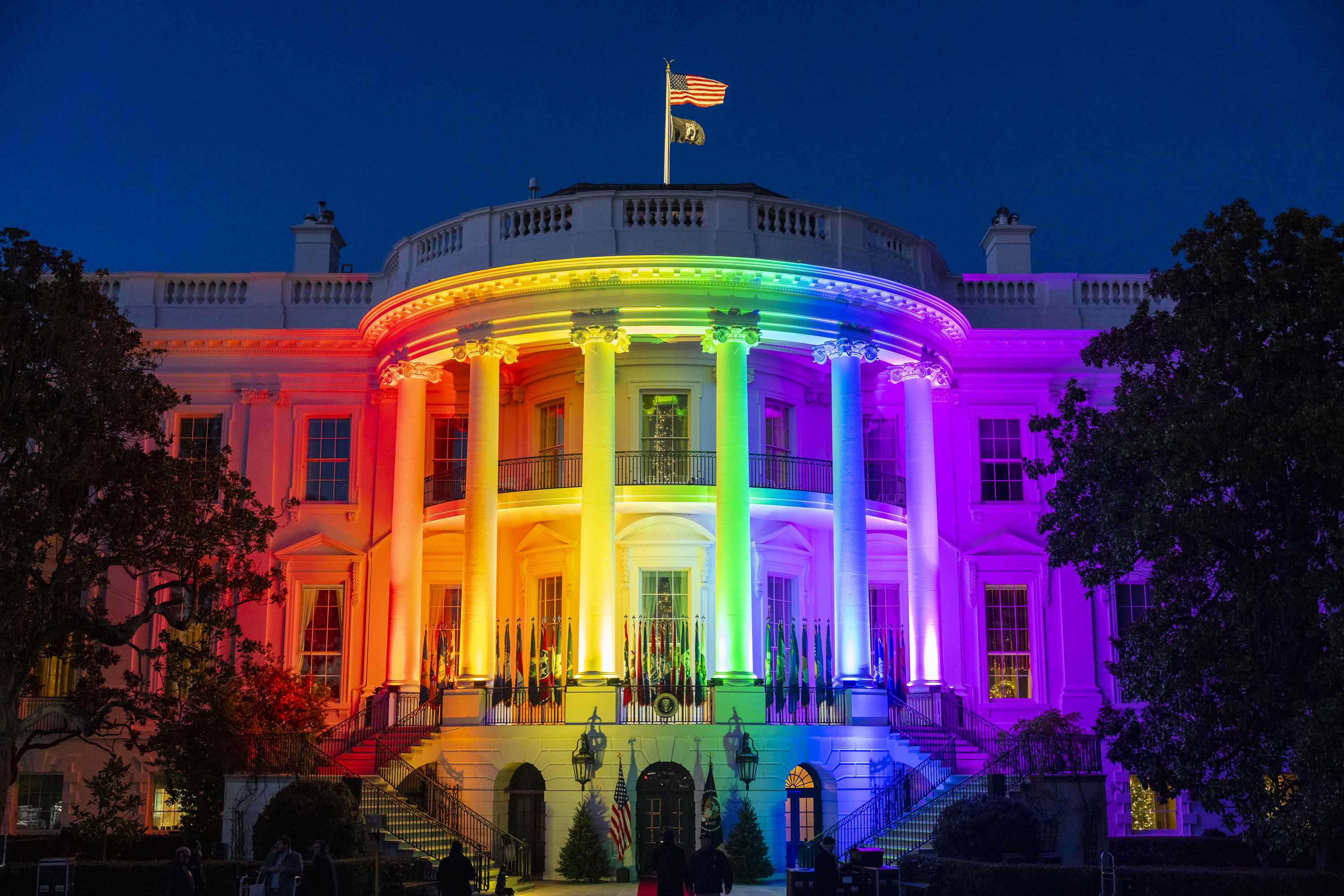 The south side of the White House at night lit in rainbow colors