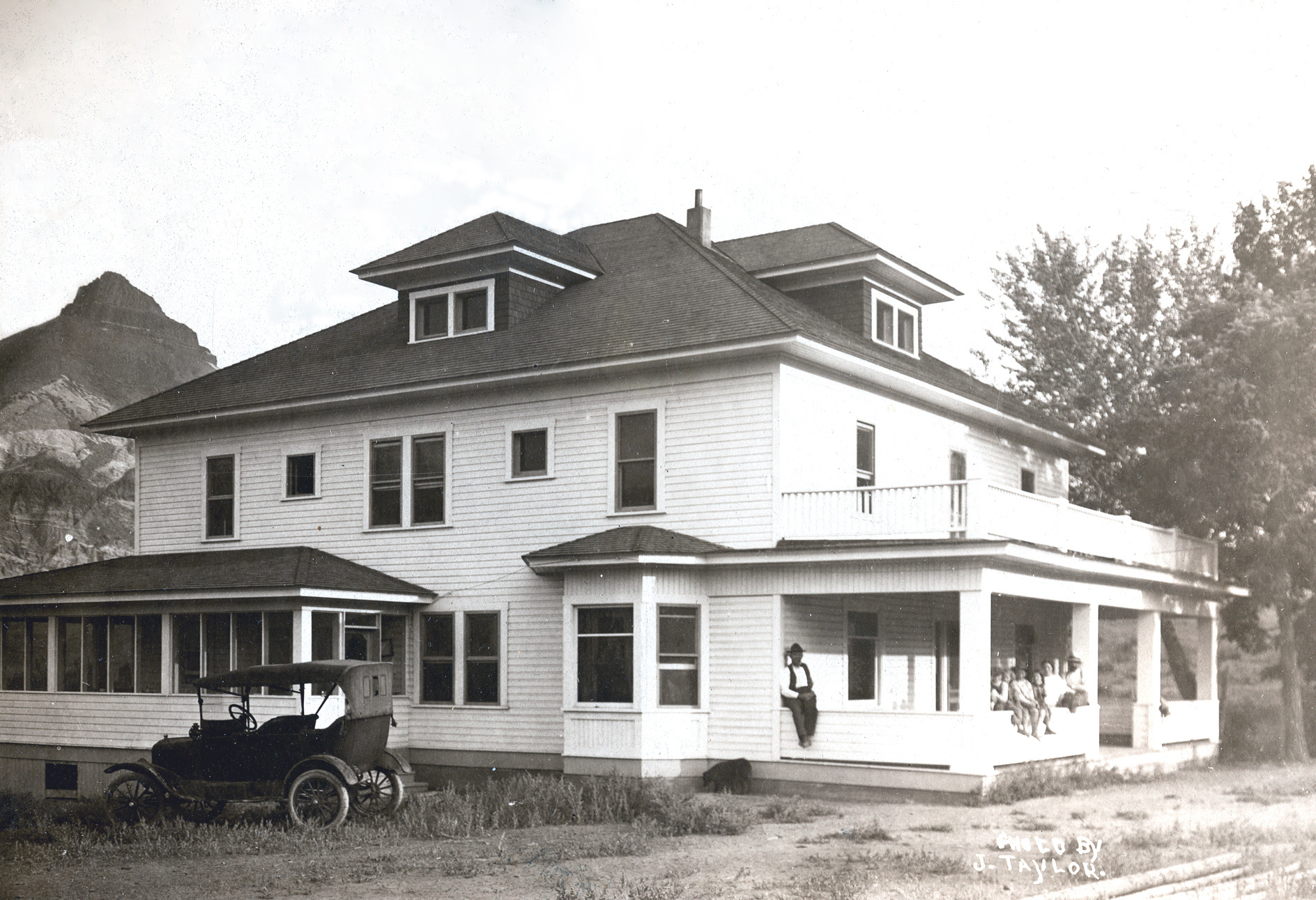 A black and white image of a ranch house.