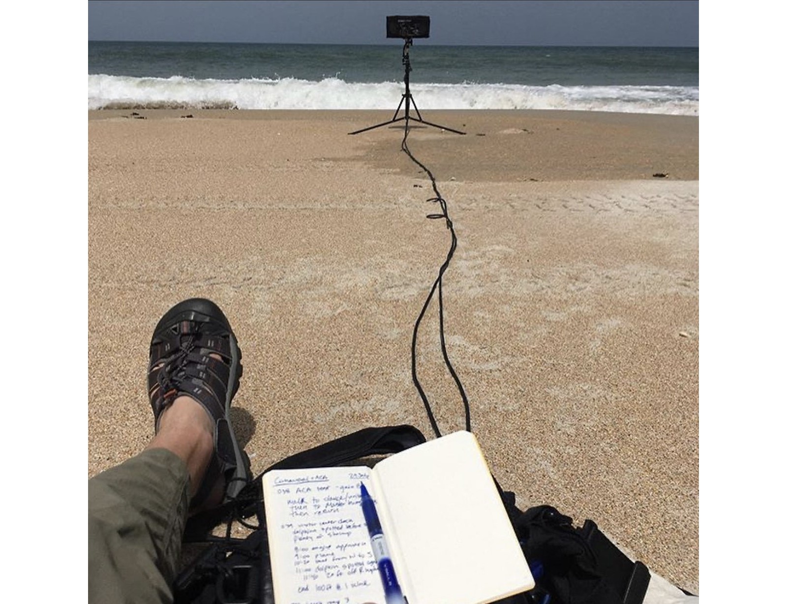 Two feet and a sound recorder on the beach.