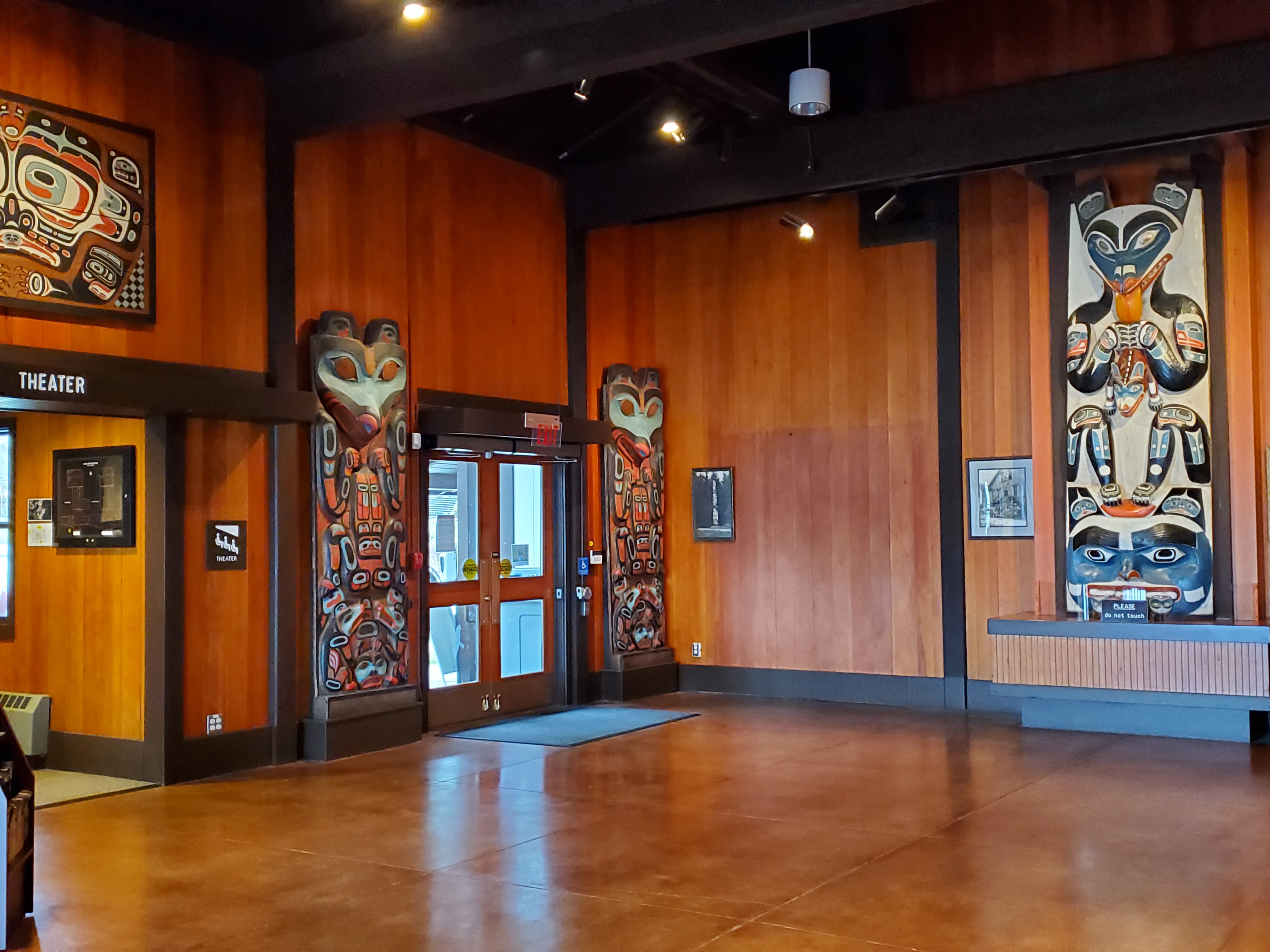 Alaska Native carved and painted posts flank the entrance doors to the visitor center.