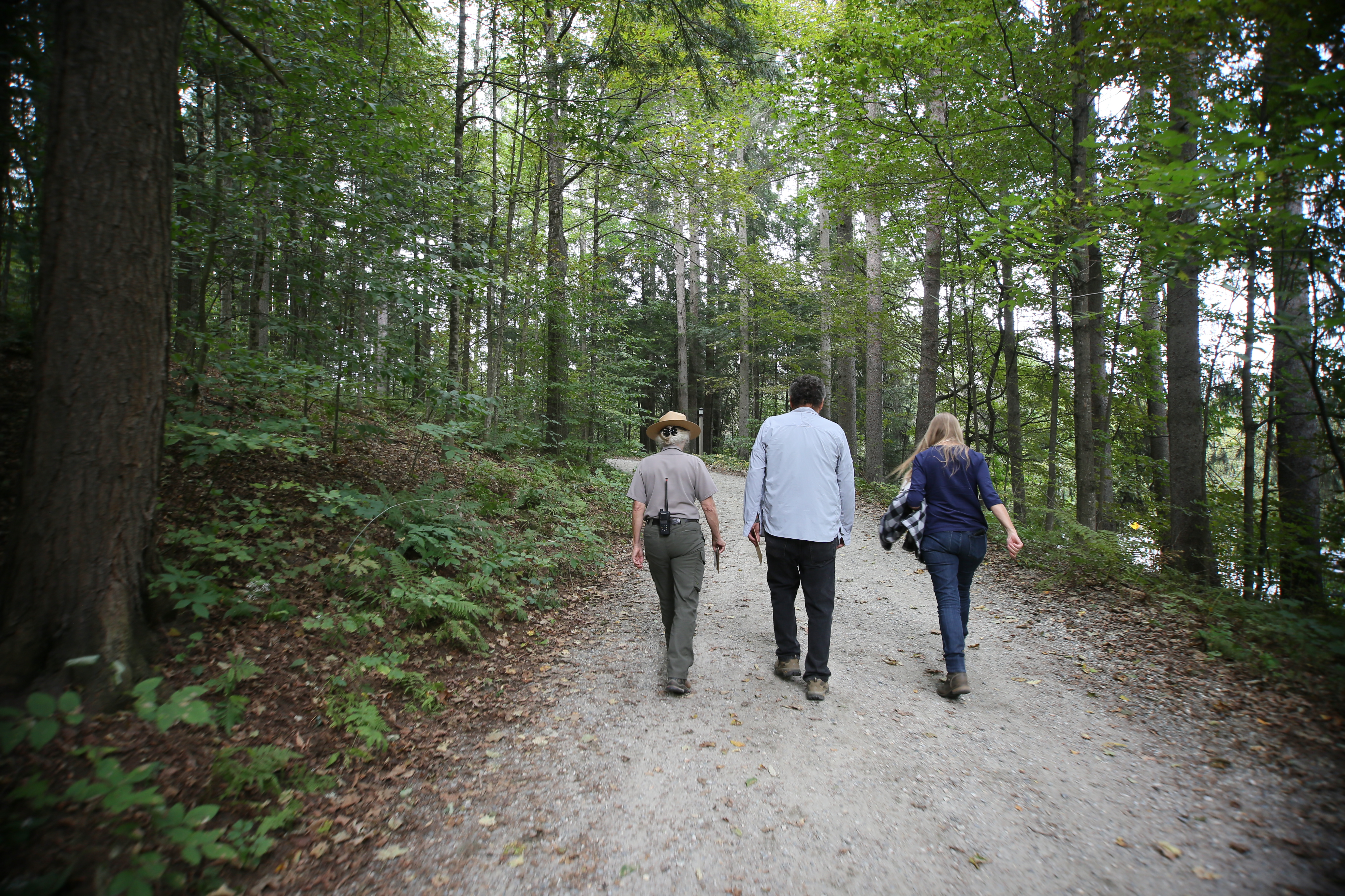 Park Ranger and visitors hiking on carriage road