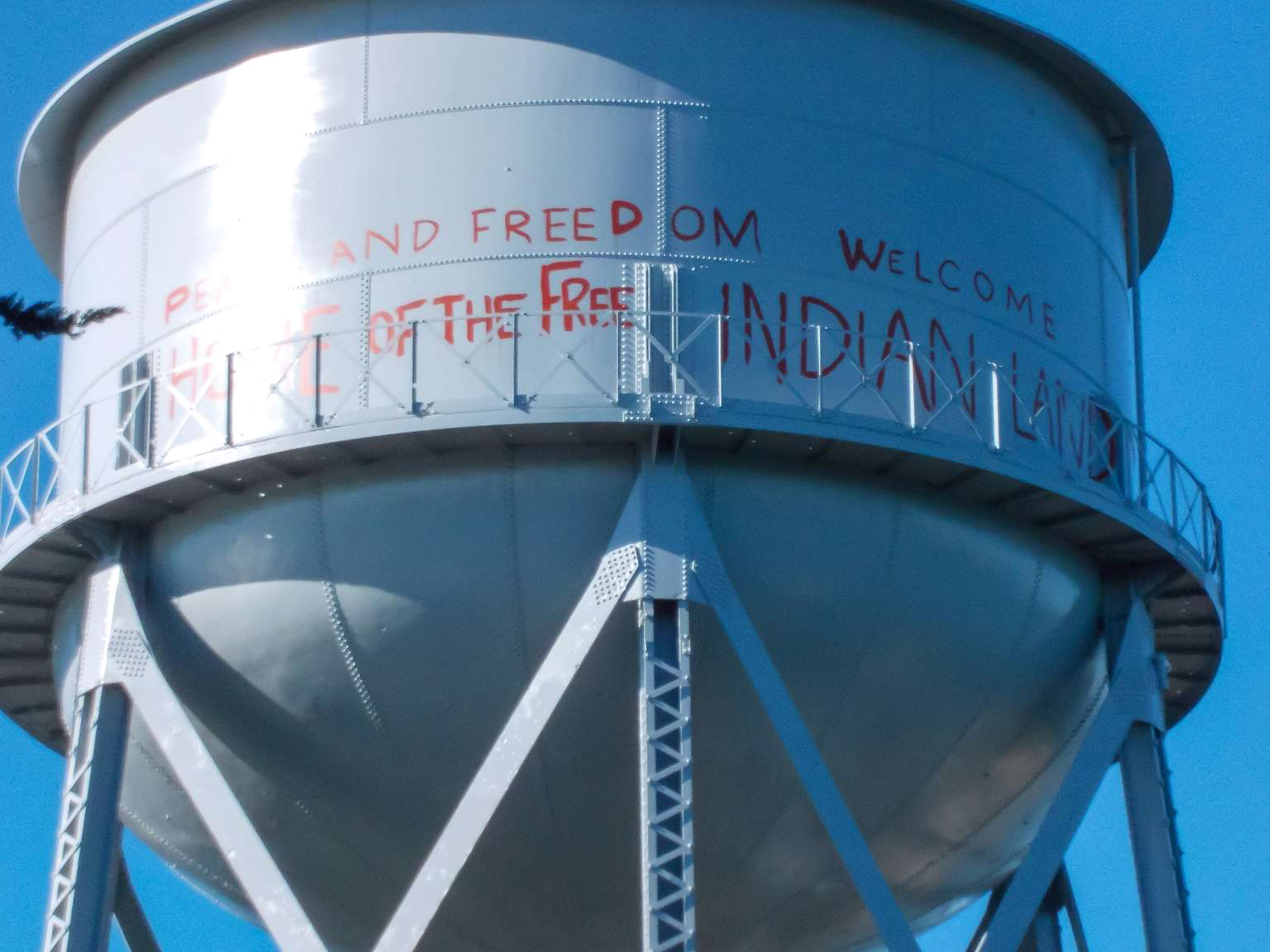 Red spray painted graffiti on the water tower on Alcatraz Island.