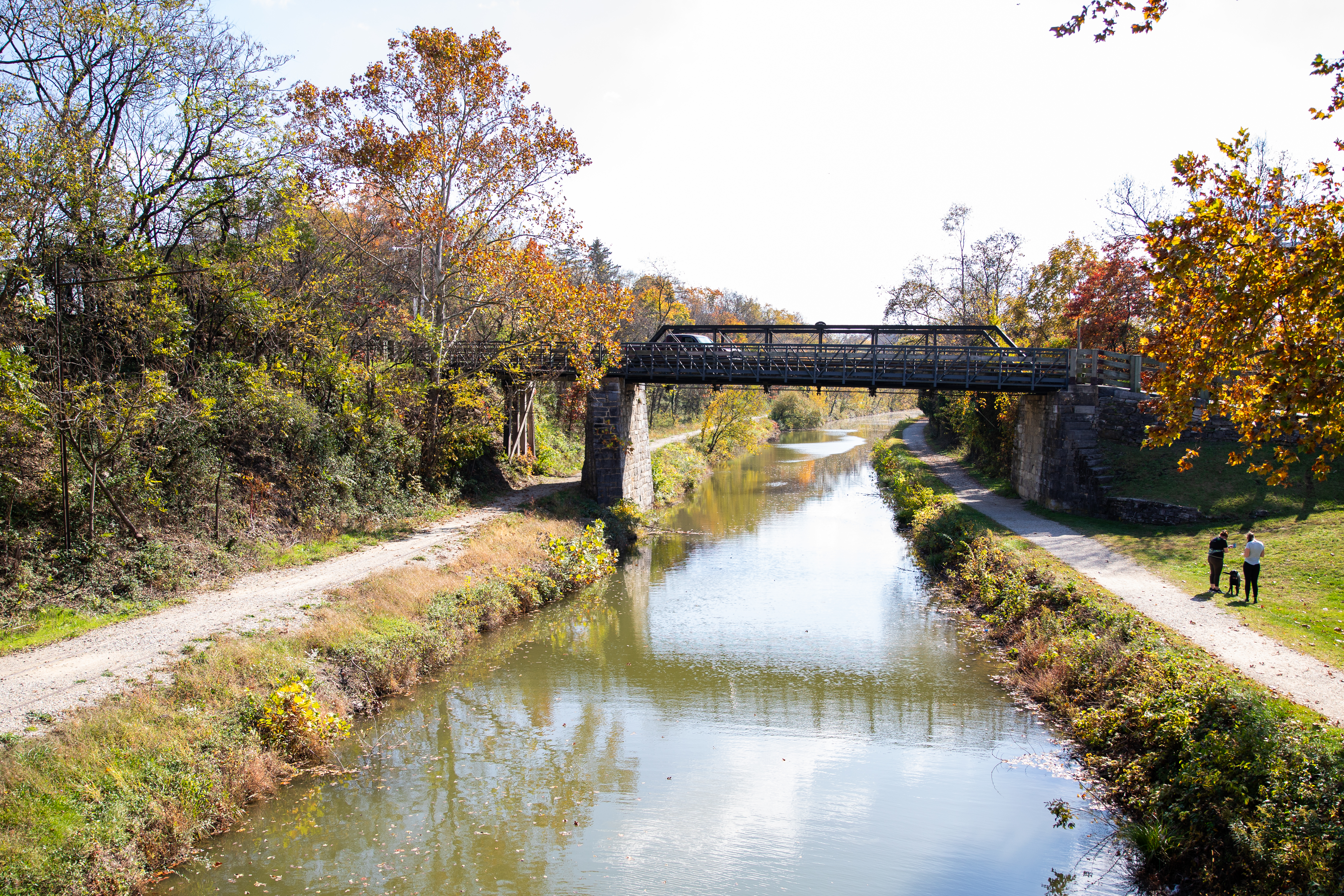 Scenic view of towpath on left, railroad trail on right, Bollman Bridge, and watered canal below