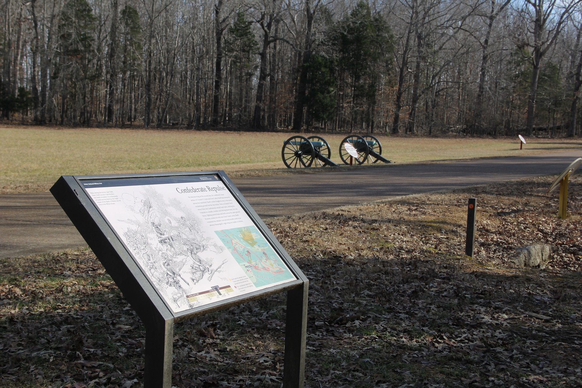 Image of a wayside exhibit with two cannon in background