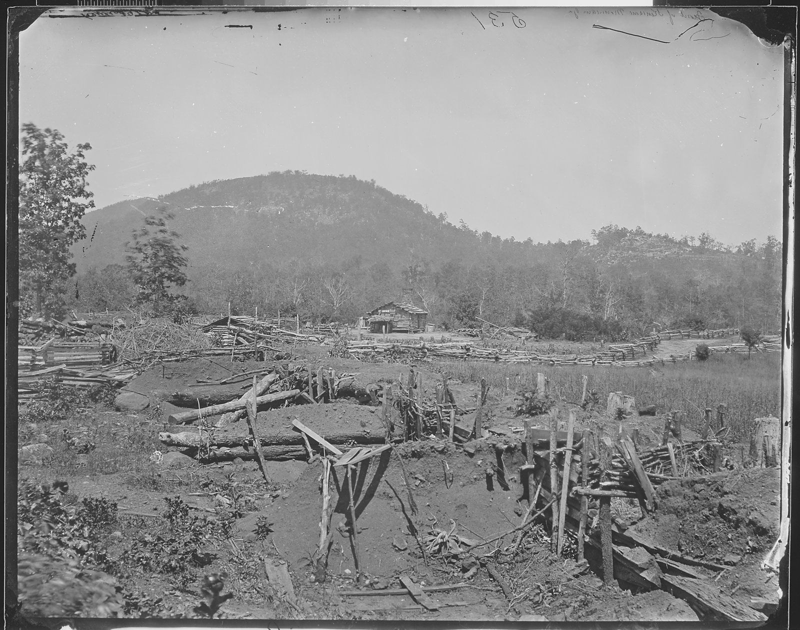 A black and white photo shows a burnt and blown up landscape after a major Civil War battle