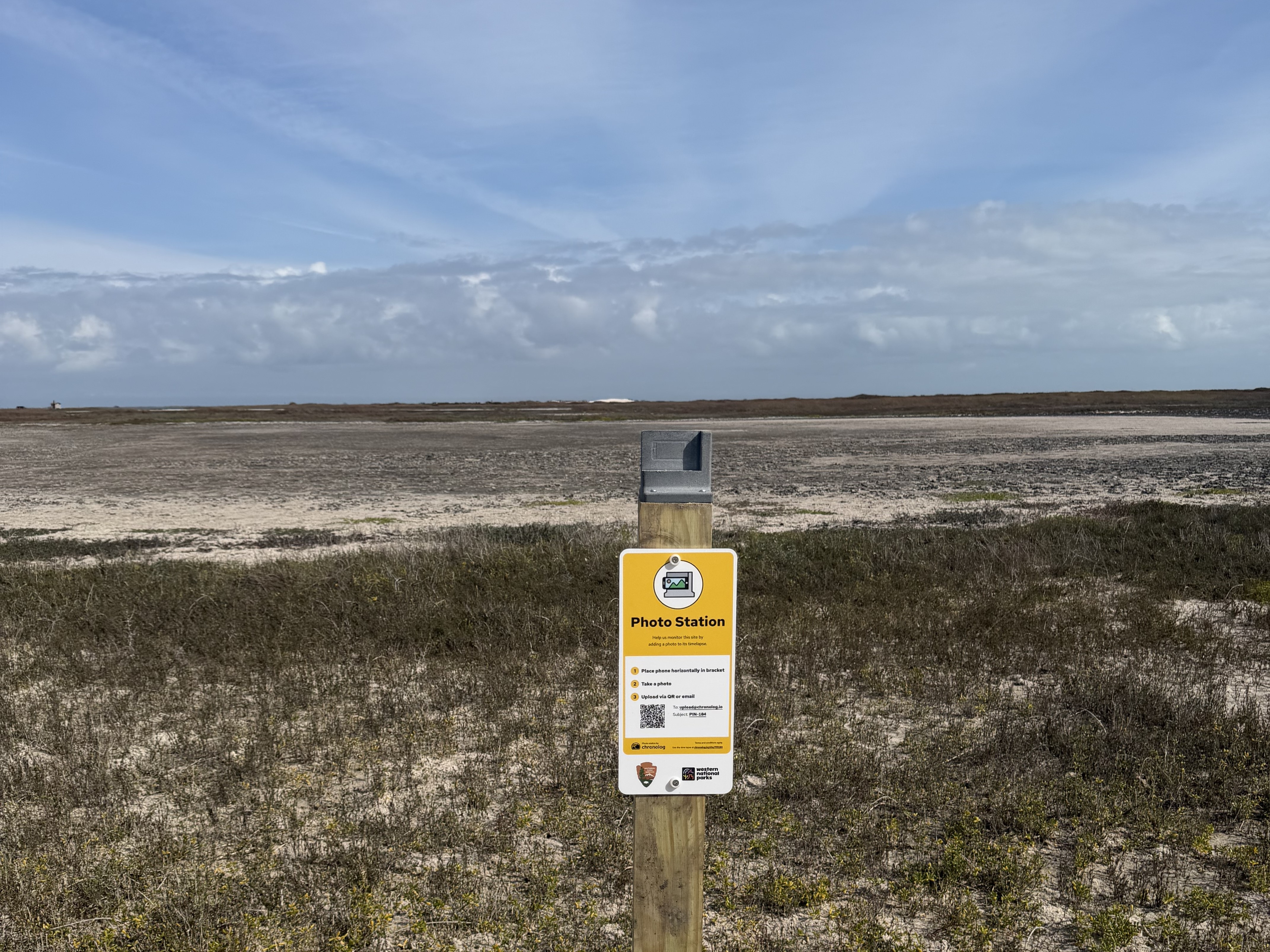 A photo monitoring station attached to a wooden post.